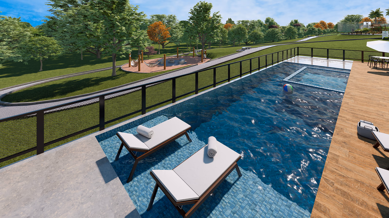 Piscina com espreguiçadeiras e espaço luau ao fundo